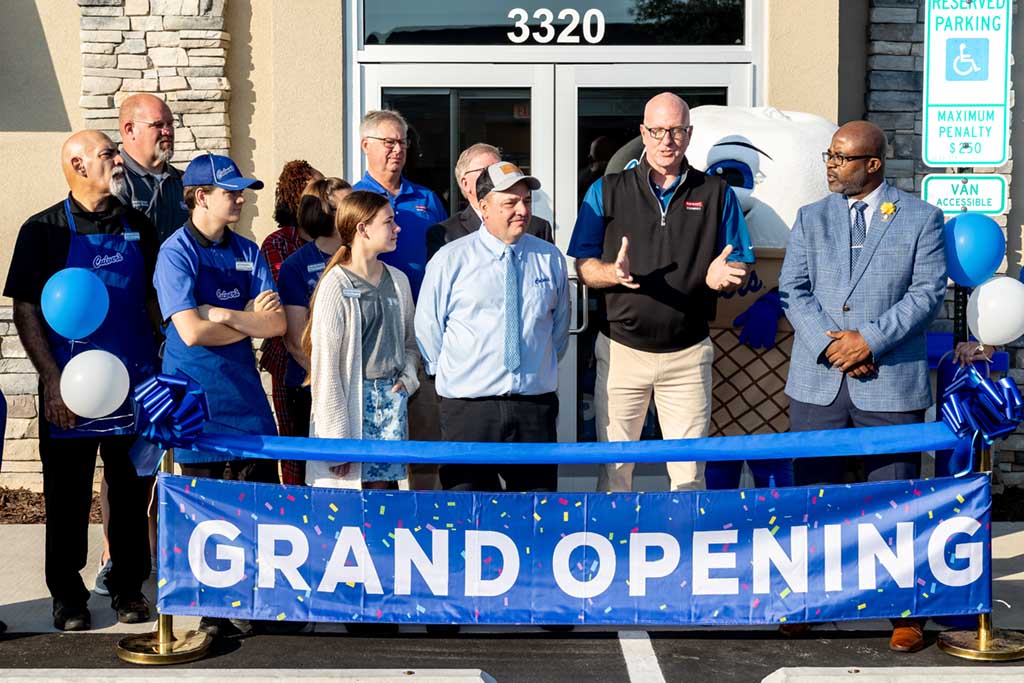 Greg West speaking at the grand opening of a new business.