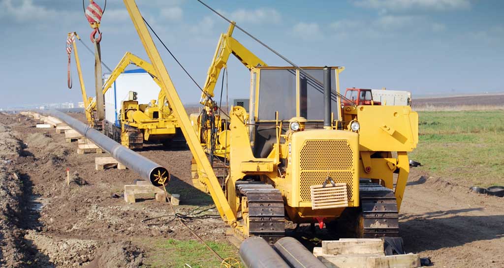 Large machinery installing pipeline infrastructure.